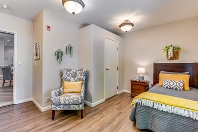 Cozy resident room with a bed and seating area