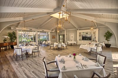 Dining area with elegantly set tables and natural light