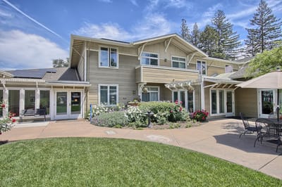 Exterior view of the assisted living facility with gardens
