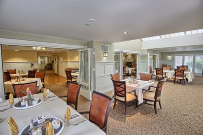 Well-decorated dining room with tables set for meals