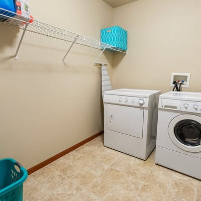 Laundry room with washer and dryer in assisted living facility