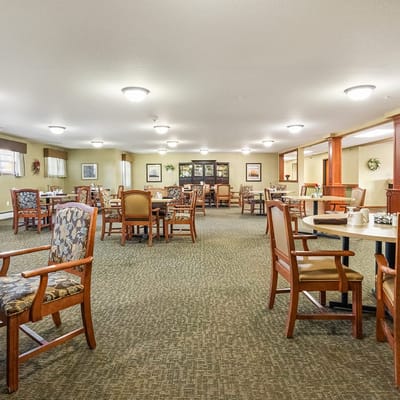 Common area seating with tables in a bright interior