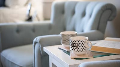 Cozy chairs with coffee cups on a table