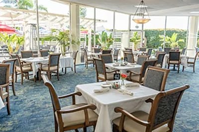 Dining area with tables set for residents