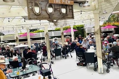 Residents enjoying an outdoor meal in a social setting