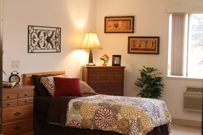 Cozy resident room with bed and decor