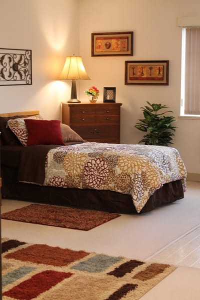 Cozy bedroom with floral bedding and a lamp