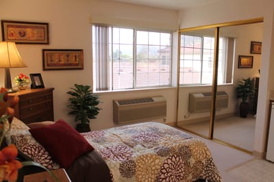 Cozy interior of a resident's room with a bed and decorations