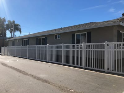 Exterior view of a building with a white fence