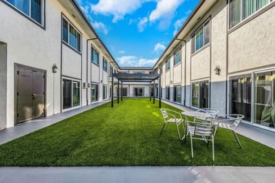 Outdoor courtyard with seating area and grass