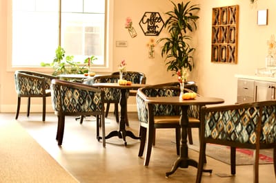 Bright common area with decorated tables and chairs