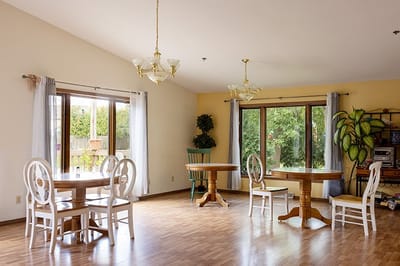 Bright common area with tables and windows