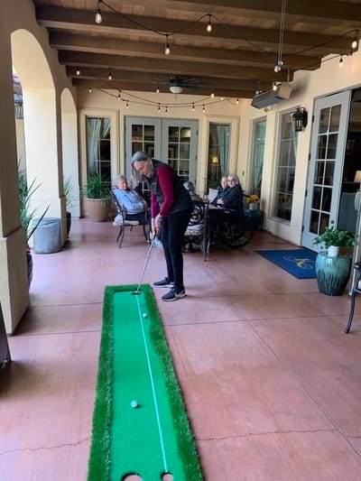 Residents enjoying mini-golf on a patio