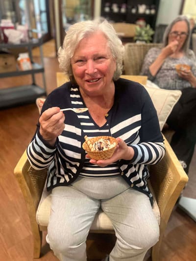 A resident enjoying ice cream in a common area