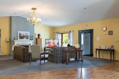 Common area with seating and television in a senior living facility