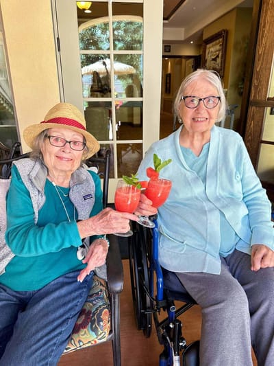 Two residents enjoying mocktails on a patio