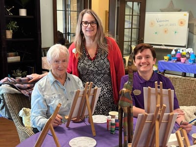 Residents participating in a painting activity in a communal space