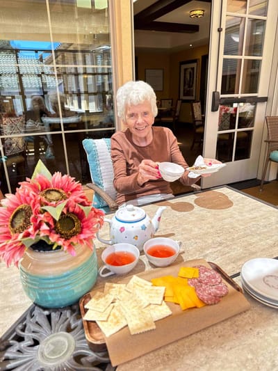 Resident enjoying tea and snacks outdoors