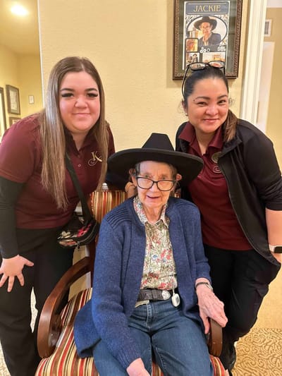 Staff members with a resident in a common area