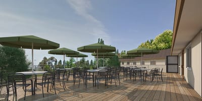 Outdoor patio area with tables and umbrellas