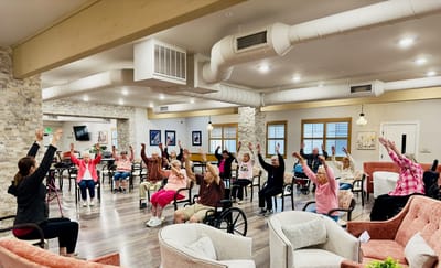 Residents participating in an exercise class indoors