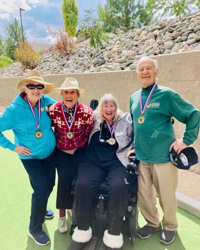 Residents proudly displaying medals outdoors