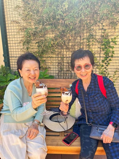 Two residents enjoying ice cream sundaes outdoors