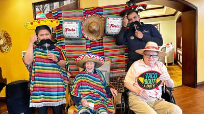 Residents and staff celebrating a fiesta with sombreros