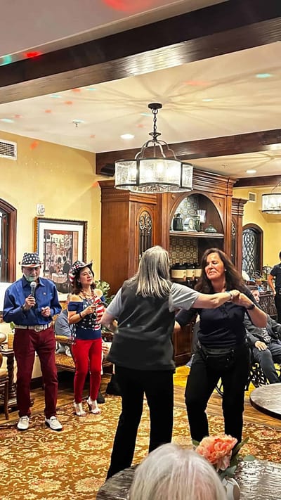 Residents and staff enjoying a dance party in a common area