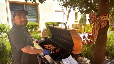 Staff grilling food in an outdoor area