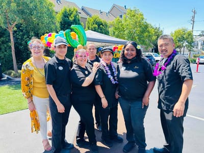 Staff members celebrating with colorful decorations