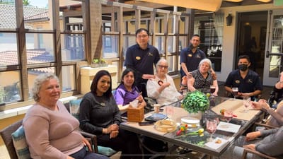 Residents and staff enjoying a social gathering in a common area