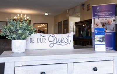 Welcoming lobby with a 'Be Our Guest' sign