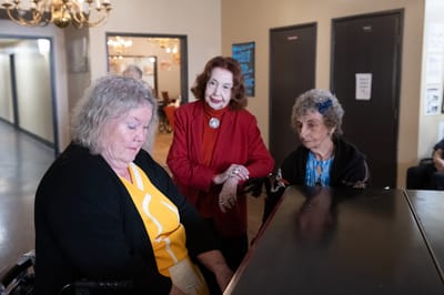 Residents engaging in a music activity in a hallway