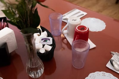 Table setting with jelly and cups in a dining area