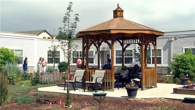 Residents socializing in a gazebo in the garden