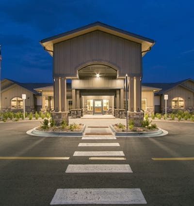 Front view of a modern assisted living facility at night