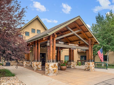 Exterior view of the facility entrance with wooden architecture