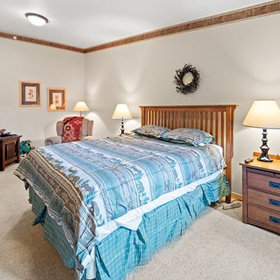 Cozy private bedroom with lamps and artwork