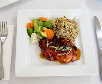 Plated meal with chicken, rice, and vegetables