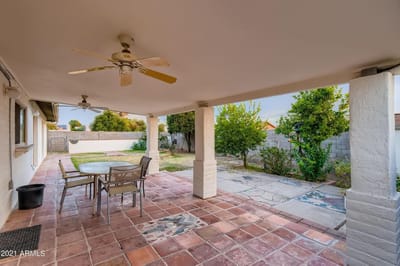 Covered patio area with table and chairs