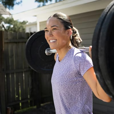 Adventhealth Avista, Nursing Home in Louisville, CO — Woman lifting weights in an outdoor setting