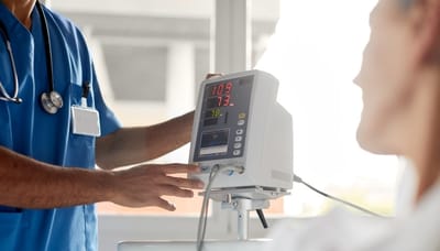 Medical staff checking a patient's monitor