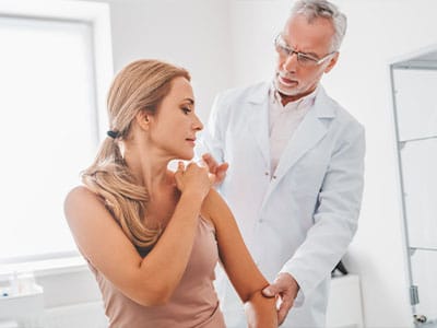 Doctor consulting with a female patient in a clinical setting