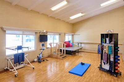 A physical therapy room with exercise equipment