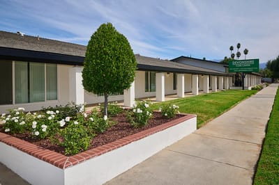 Exterior view of Devonshire Care Center with landscaping