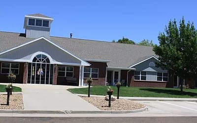 Exterior view of a nursing home building surrounded by landscaping