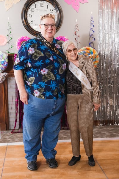 Residents celebrating with crowns at a party