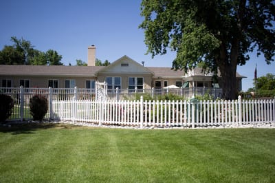 Exterior view of Spring Ridge Park Assisted Living building with garden