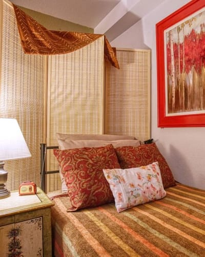 Cozy private room with decorative pillows and artwork